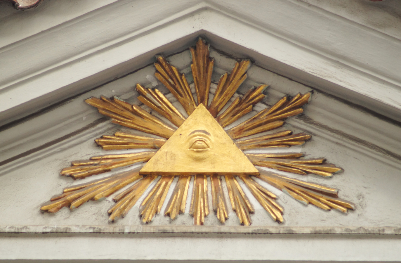 Illuminati sign on building pediment close up.